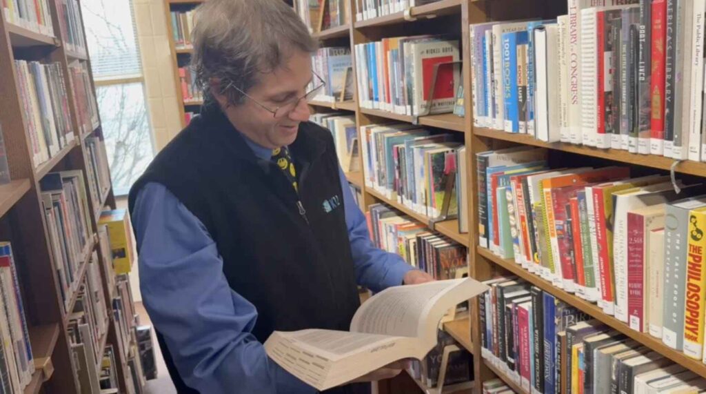 Larry Biederman in a library